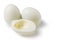 Boiled peeled eggs on a white background, two whole eggs, one egg cut in half, half without yolk, concept