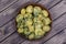 Boiled potatoes with dill, garlic and butter in a plate on wooden table