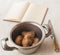 Boiled potatoes in a saucepan and book of recipes