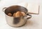 Boiled potatoes in a saucepan and book of recipes