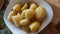 Boiled potatoes on a white bowl. Vegan food that has not yet been served.