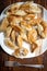 Boiled prepared homemade russian dumplings or pelmeni on the patterned plate with a fork