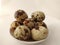 Boiled Quail eggs in the plate on the white background.