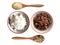 Boiled rice in bowl with raw cereal rice in wooden spoon between jasmine and riceberry rice top view isolated on white background.