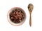 Boiled rice in bowl with raw riceberry rice in wooden spoon top view isolated on white background.