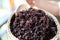 Boiled riceberry rice on wood basket with spoon