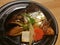 Boiled salmon head in sweet soya sauce served with carrot and tofu in a local Japanese restaurant, traditional Japanese food,