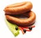 Boiled sausage decorated with red pepper, olive and salad