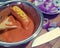 Boiled sausages in tomato mayonnaise sauce seasoned with mustard. Red sweet onion as garnish. Spicy hot yummy snack