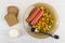 Boiled sausages, vegetable mix, pieces of bread, bowl with mayonnaise