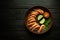 Boiled shrimp are laid out on a plate with parsley and vegetables. The concept of setting a dark table in a hotel or restaurant