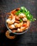 Boiled shrimps with glass bowl with parsley