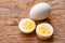 Boiled sliced chicken eggs on wooden table