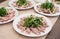 Boiled sliced meat with herbs and sauce on the kitchen counter