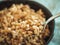 Boiled spelt in spoon, selective focus