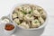 Boiled or steamed pelmeni in white bowl. Pelmeni are homemade pasta with mince meet filling wrapped in thin wheat dough