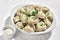 Boiled or steamed pelmeni in white bowl. Pelmeni are homemade pasta with mince meet filling wrapped in thin wheat dough