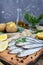 Boiled unpeeled potatoes in skins, a small salted fish of Baltic herring, sprats