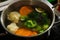 boiled vegetables lie in water in metal vessel