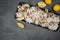 Boiled webfoot octopus dish decorated with lemon slices on gray concrete table