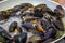 Boiling blue mussels in white wine closeup