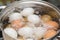 Boiling chicken eggs in the pan