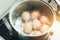 Boiling eggs in pot hot water