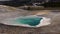 Boiling hot crystal clear water in a geyser. Yellowstone National park. Wyoming, USA