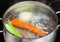 Boiling meat broth in stew pan close up