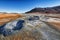 Boiling mudpots in the geothermal area Hverir and cracked ground around