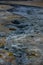 Boiling mudpots in the geothermal area Hverir and cracked ground around, Iceland in summer. Myvatn region, North part of Iceland