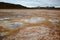 Boiling mudpots in the geothermal area Hverir and cracked ground around, Iceland in summer. Myvatn region, North part of Iceland