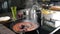 Boiling octopus in frying pan in kitchen. Saucepan, electric oven and utensil in background. Cooking seafood dish at