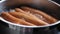 Boiling sausages on stove macro shot