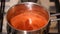 Boiling strawberry puree in a saucepan.