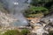 Boiling water and hot steam venting from Caldeira Grande Big boiler in small town Furnas, SÃ£o Miguel island in Azores