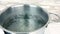 Boiling water in the pot in a kitchen, symbol of cooking or food preparation, slow motion water movement, concept of healthy