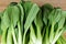 Bok Choy Leaves on Wooden Table