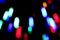 Boke. Multi-colored illumination of the night city. Colored spots, black background.