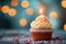 Bokeh background, birthday cupcake, burning candle, festive celebration delight