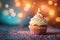 Bokeh background, birthday cupcake, burning candle, festive celebration delight