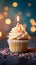 Bokeh background, birthday cupcake, burning candle, festive celebration delight