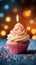 Bokeh background, birthday cupcake, burning candle, festive celebration delight