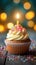 Bokeh background, birthday cupcake, burning candle, festive celebration delight