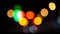 Bokeh car lights in the evening city. Defocused headlights and street lighting at night. Moving bokeh circles of cars at