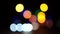 Bokeh car lights in the evening city. Defocused headlights and street lighting at night. Moving bokeh circles of cars at