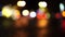 Bokeh car lights in the evening city. Defocused headlights and street lighting at night. Moving bokeh circles of cars at