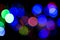 Bokeh colorful multi-colored lights yellow red blue green. Blurry lights Christmas mood. Lights from Christmas garlands defocused