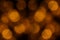 Bokeh dark orange mesh circles on black background.