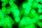 Bokeh light green defocus at night abstract background closeup.